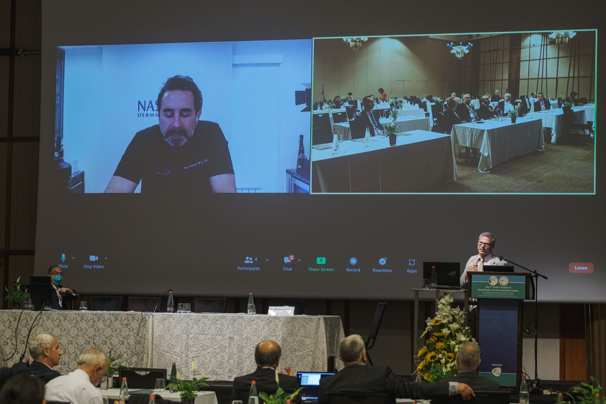 Hybrid congress session with onsite delegates and remote participants on screen